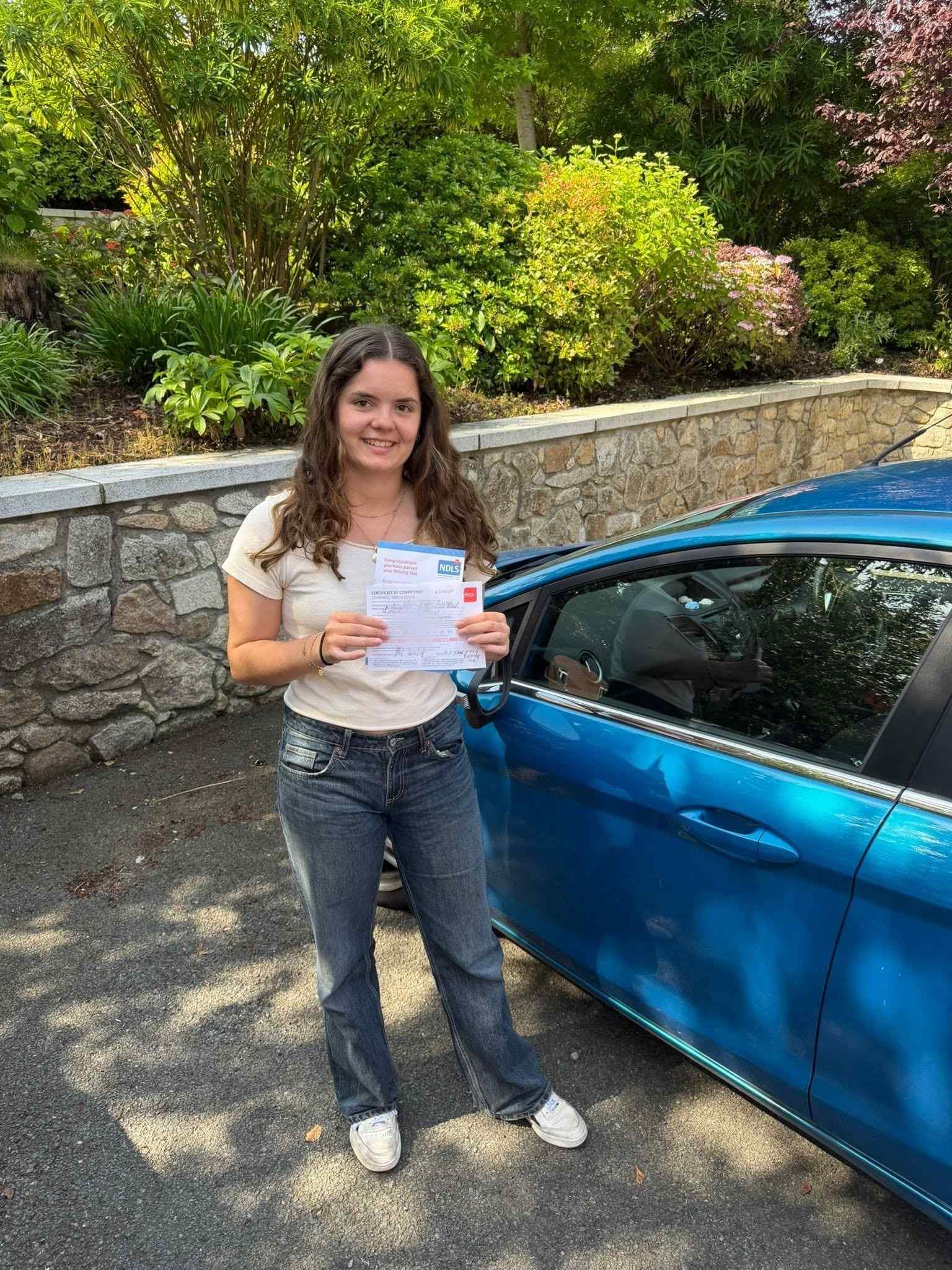 A learner driver and an instructor reviewing an affordable EDT driving lesson pricing brochure in Tallaght.