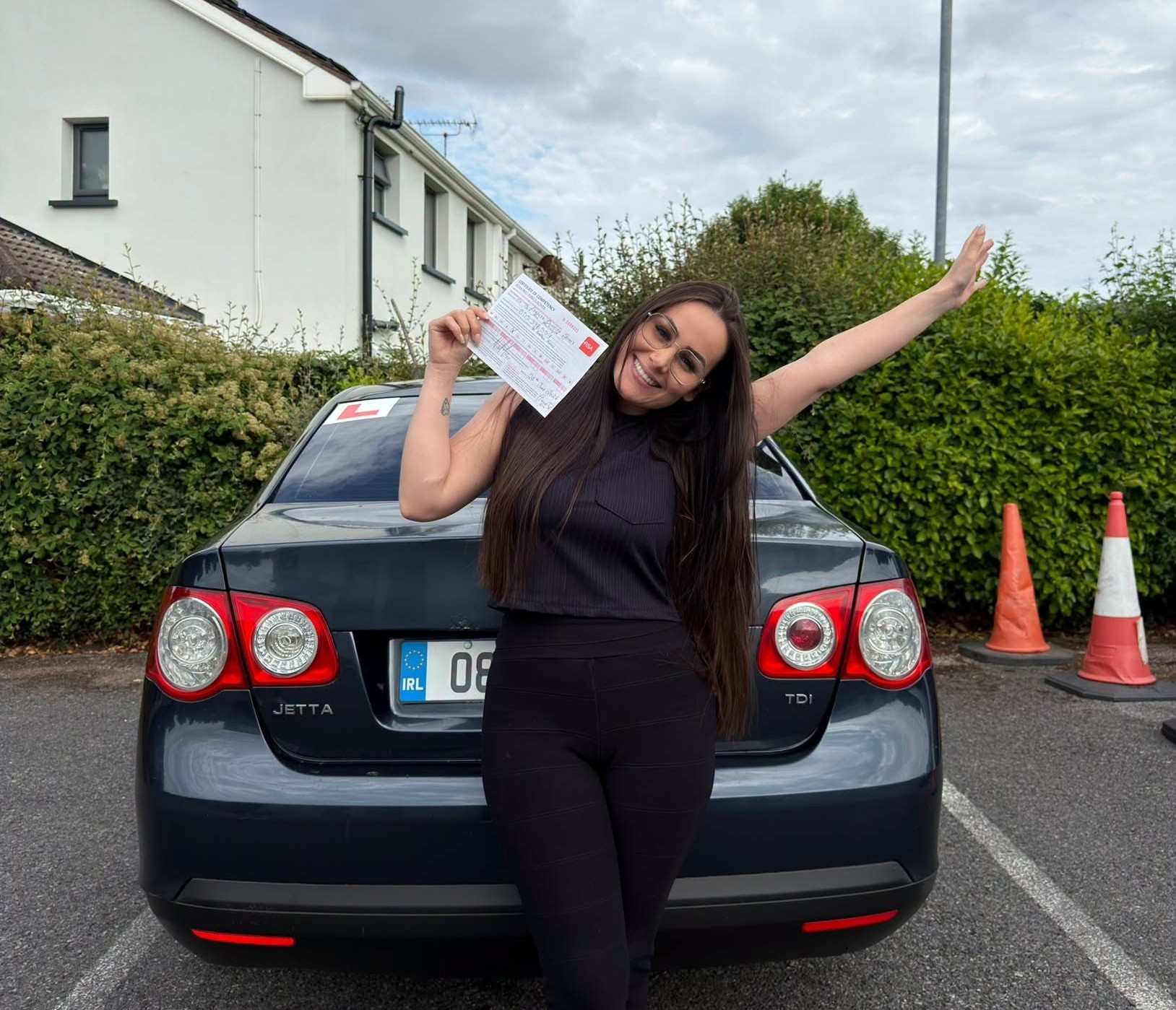 A learner driver sitting in a dual control car deciding between manual and automatic driving lessons.